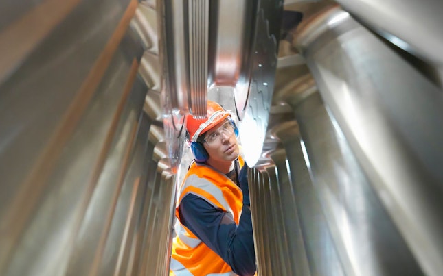 auditor-inspecting-turbine-in-power-plant.cdn