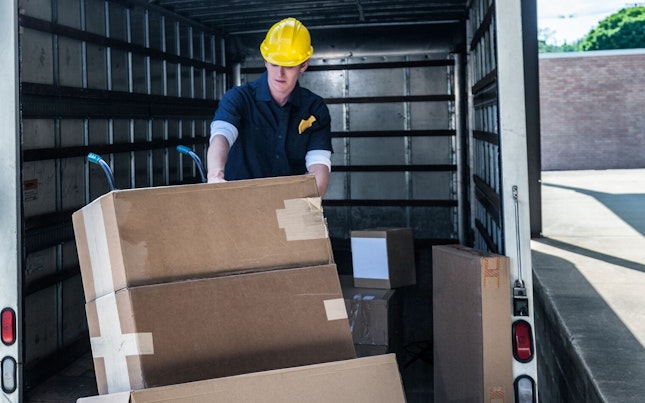 delivery-worker-loading-damaged-boxes-on-a-truck.cdn