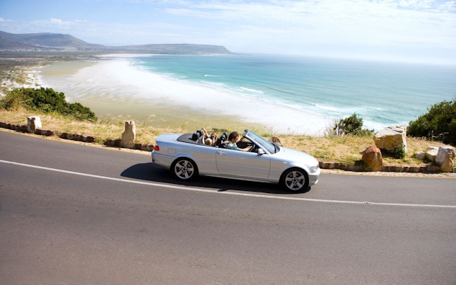 family-driving-along-the-coastline.cdn