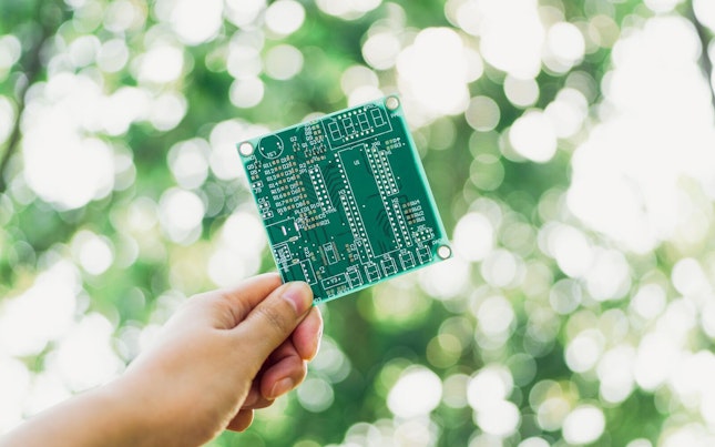 hand-holding-green-circuit-board.cdn