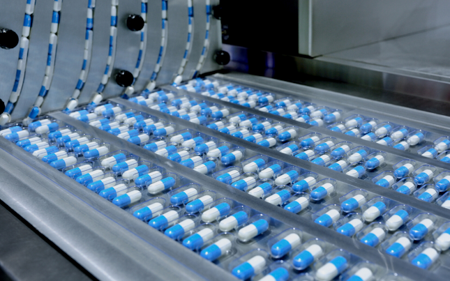 hero-blue-capsules-in-a-belt-rotary-factory-machine-1600px.cdn